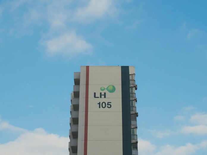 Photo by Clark Gu a tall building with a sky background