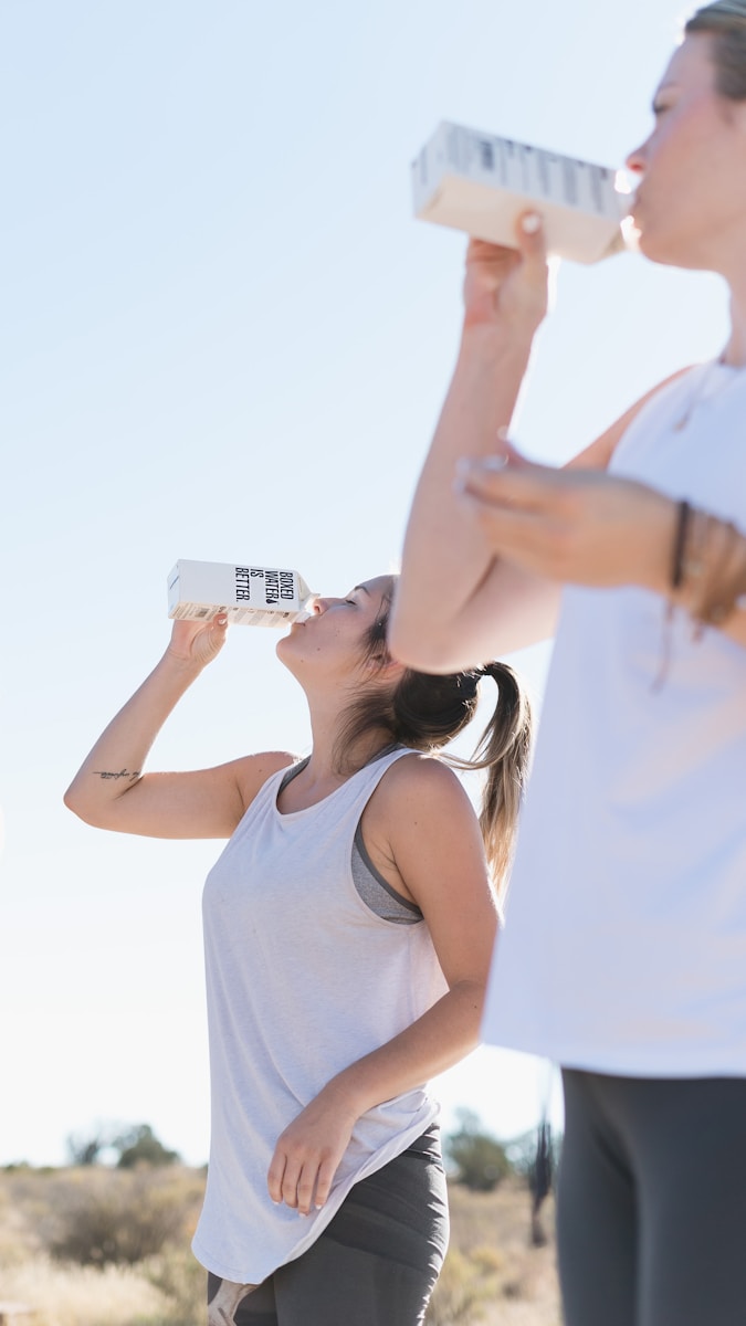 Photo by Boxed Water Is Better Two women working out and drinking Boxed Water