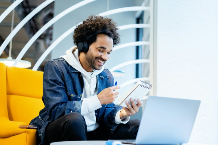 Photo by Rodeo Project Management Software a man sitting in front of a laptop computer