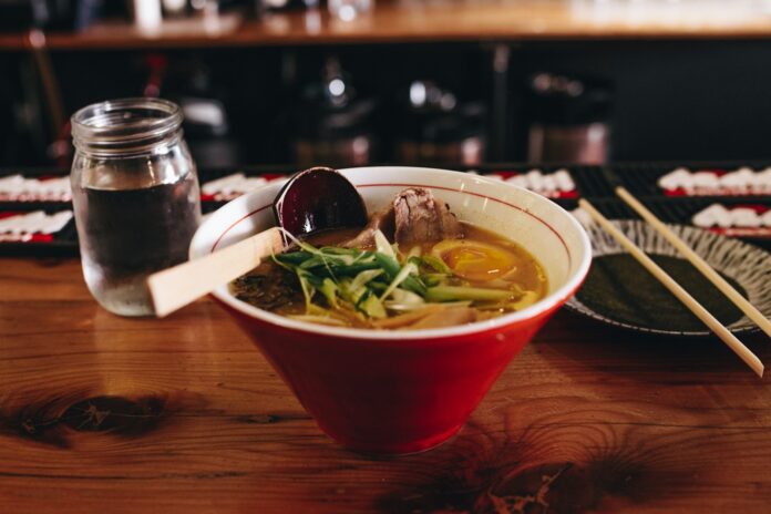 Photo by Matthew Hamilton soup with vegetable beside chopsticks and glass of water